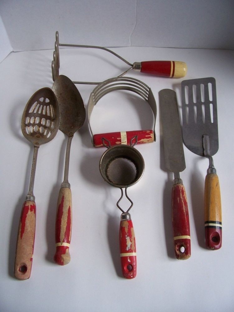 Antique collection of red wood handle kitchen utensils
