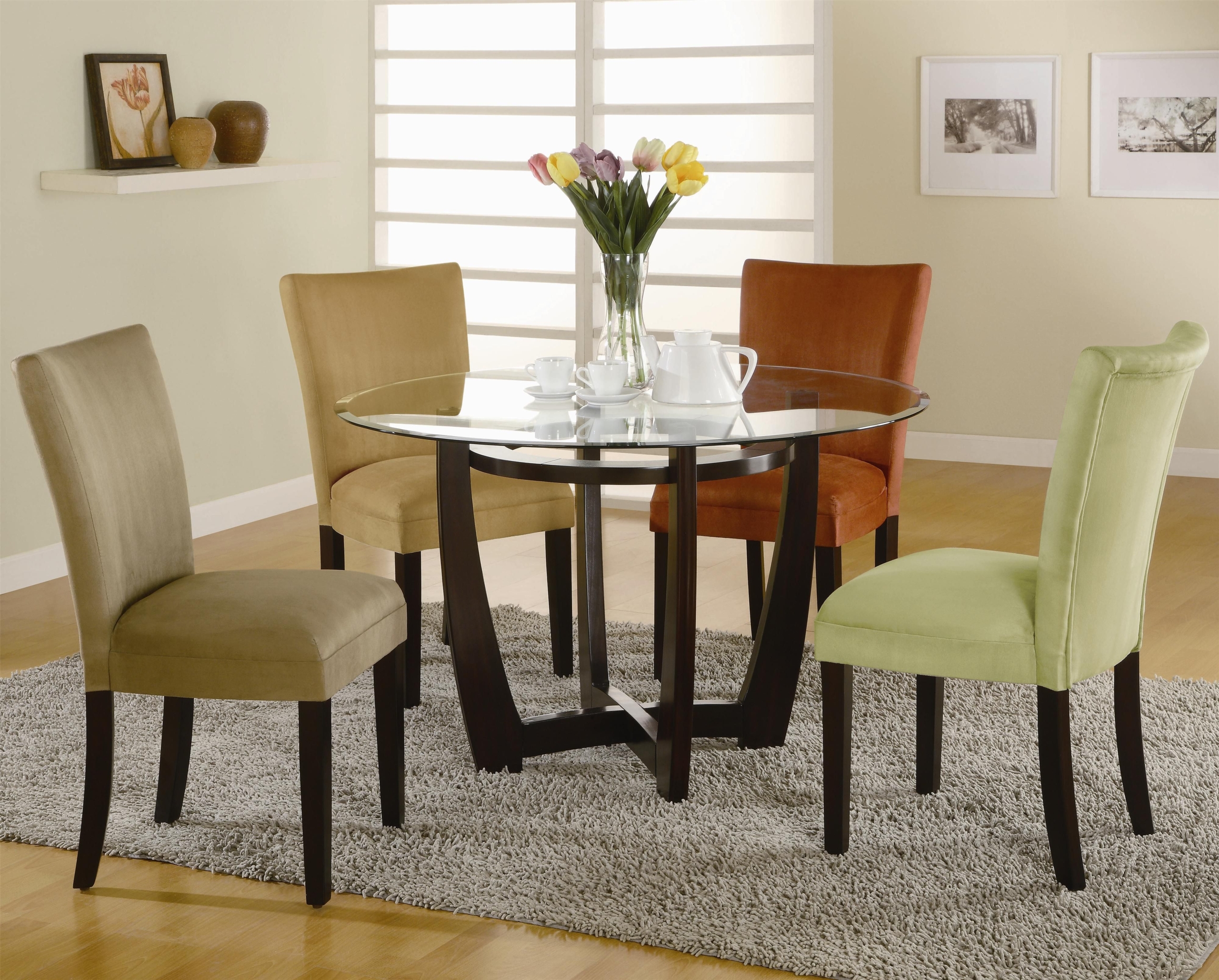 glass table with multi colored chairs