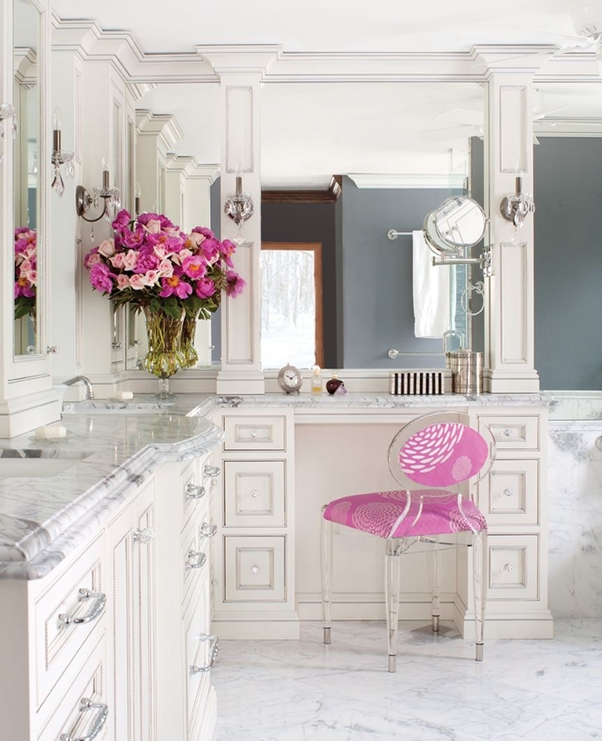 Pink vanity chair and gorgeous glass bathroom