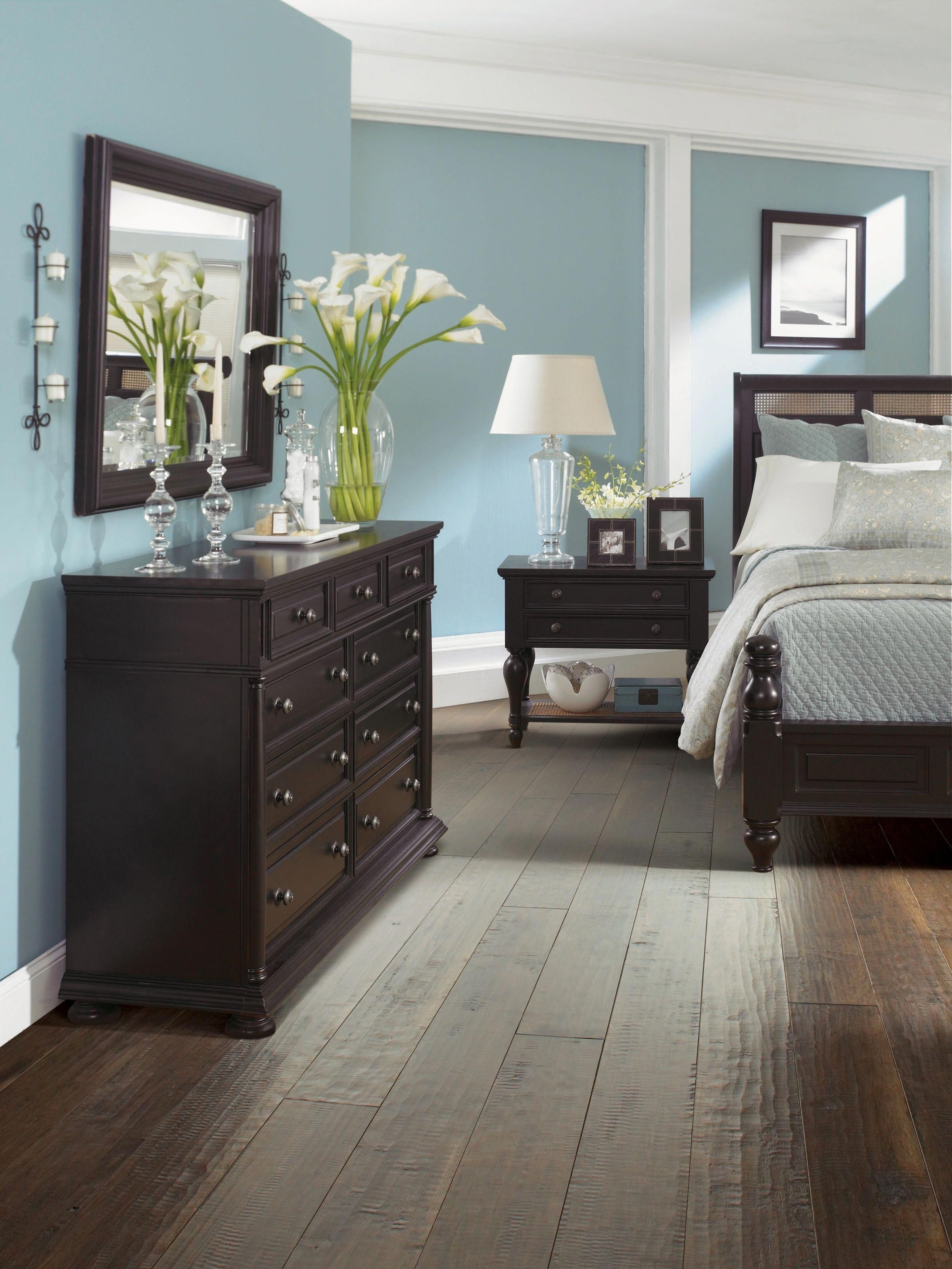 Grey bedroom with brown furniture