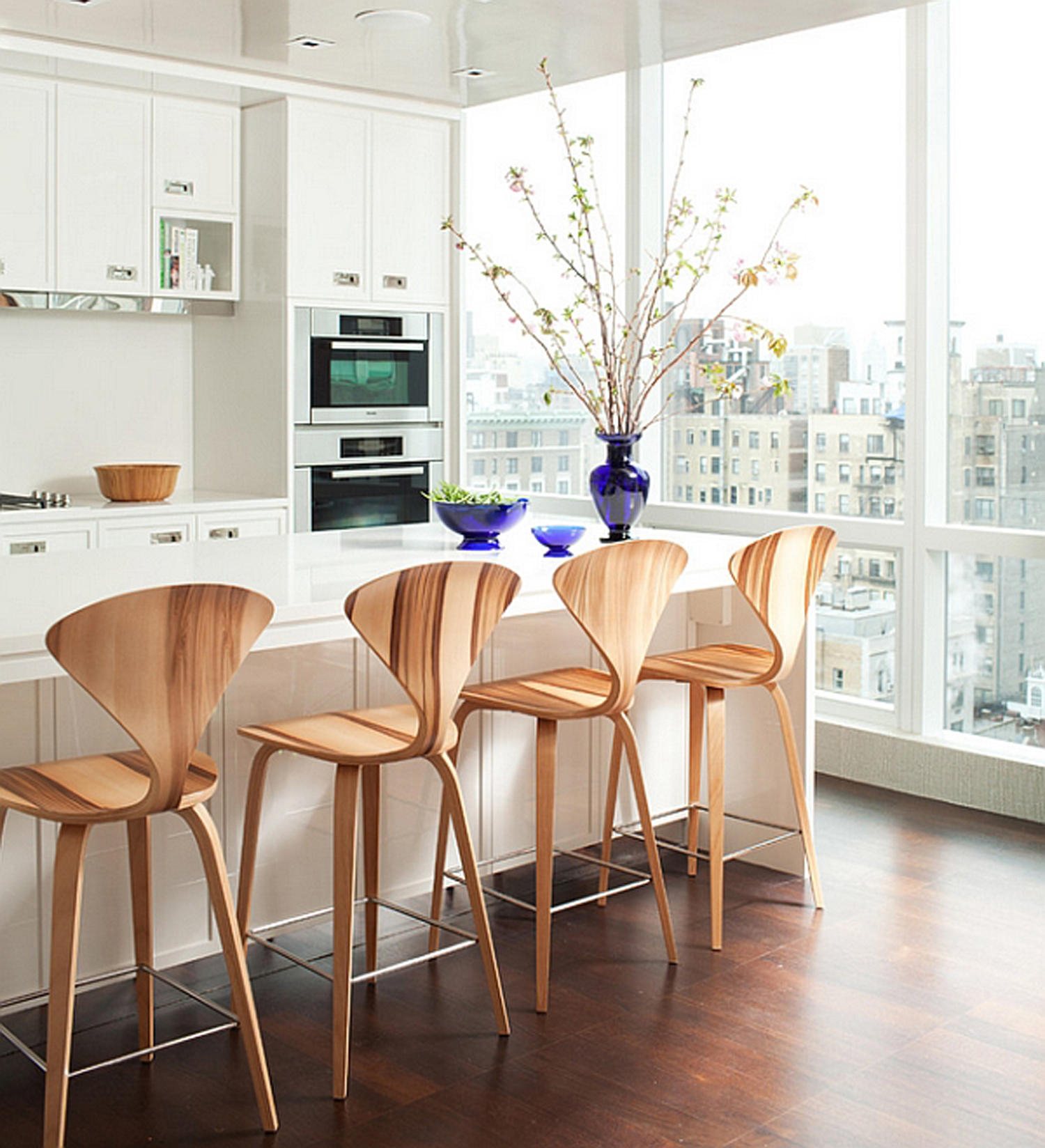 Wood barstools in white kitchen