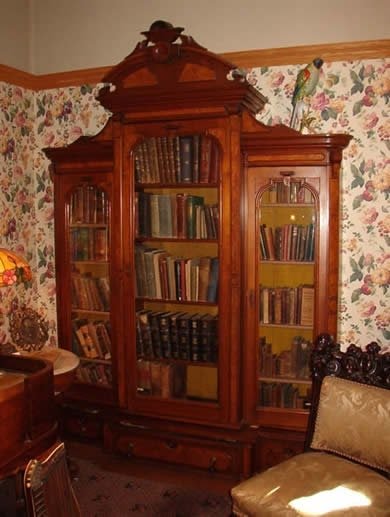 Victorian furniture bookcase on display in the victorian parlor exhibit