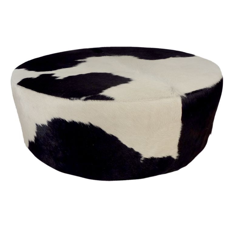 Round cowhide ottoman from a unique collection of antique and
