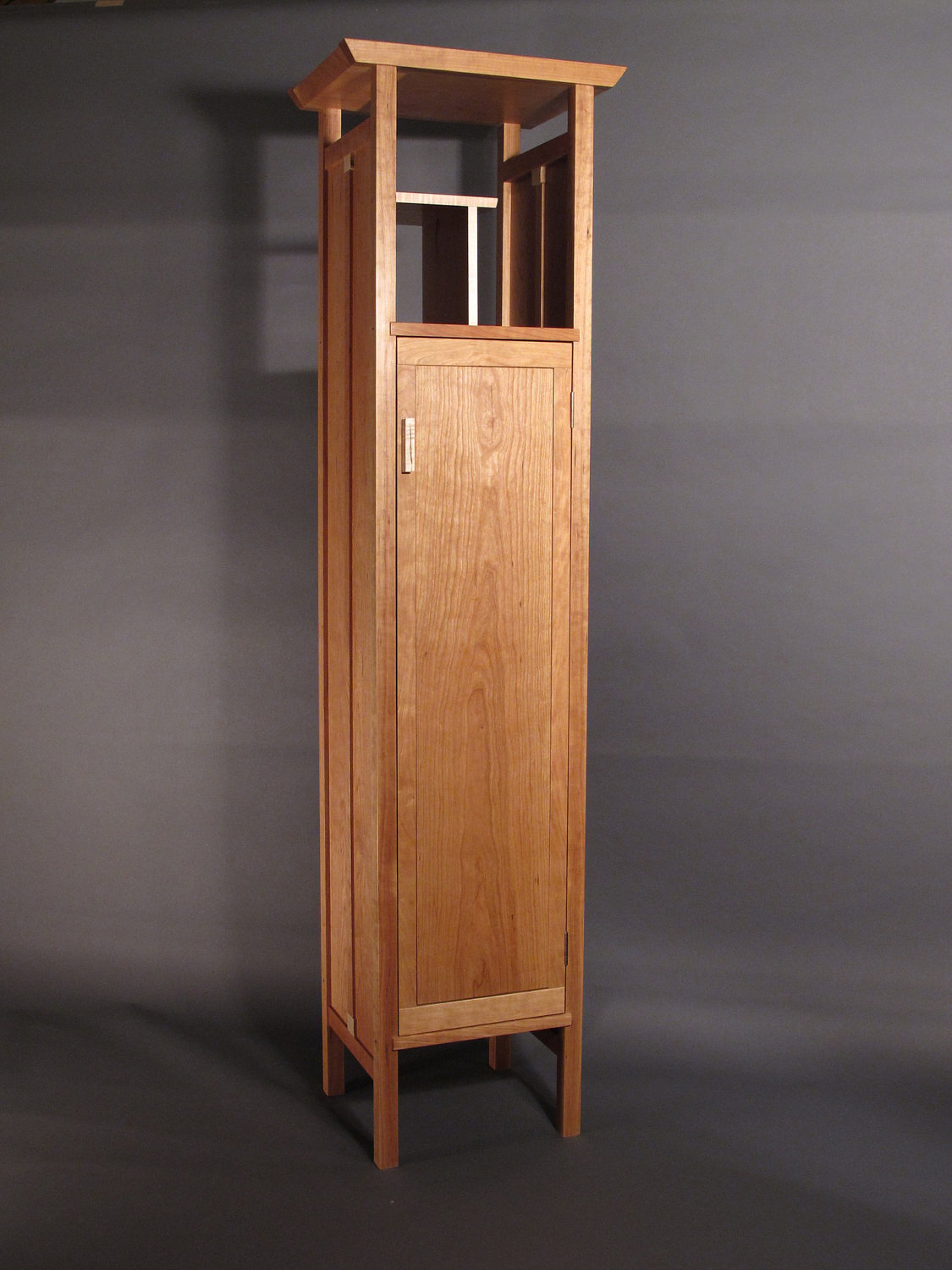 Tall narrow armoire cabinet in cherry