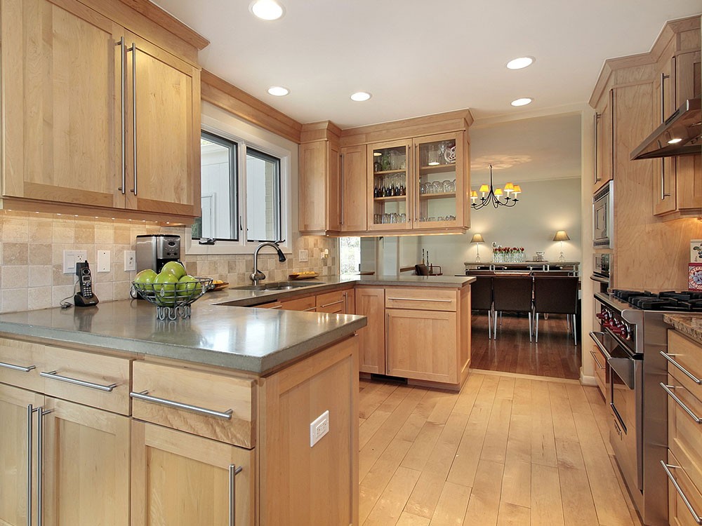 maple kitchen cabinets with white backsplash