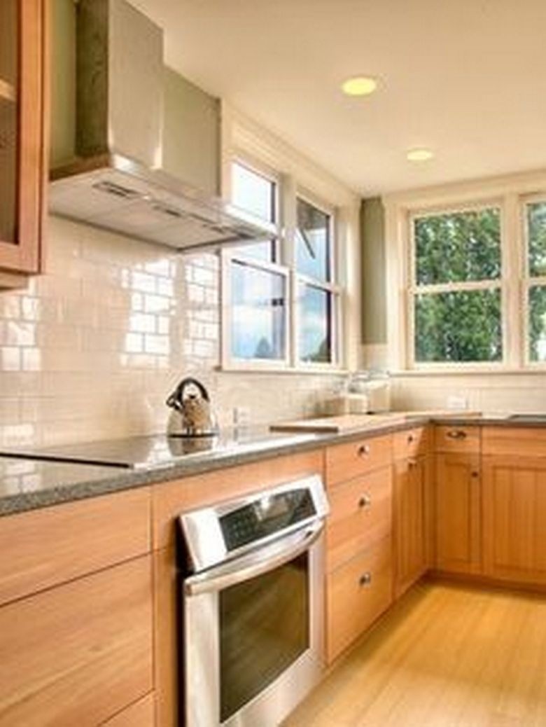 Traditional kitchen with cream glass subway tile backsplash found at