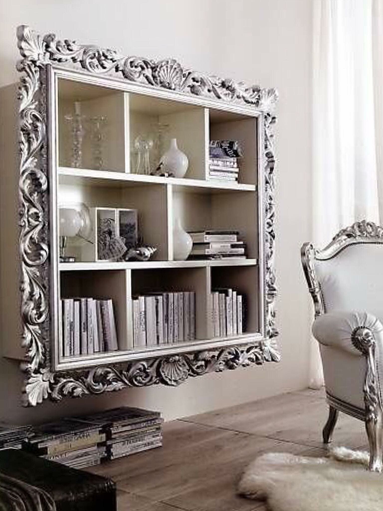 Frame an inexpensive wall shelf with ornate silver moulding it