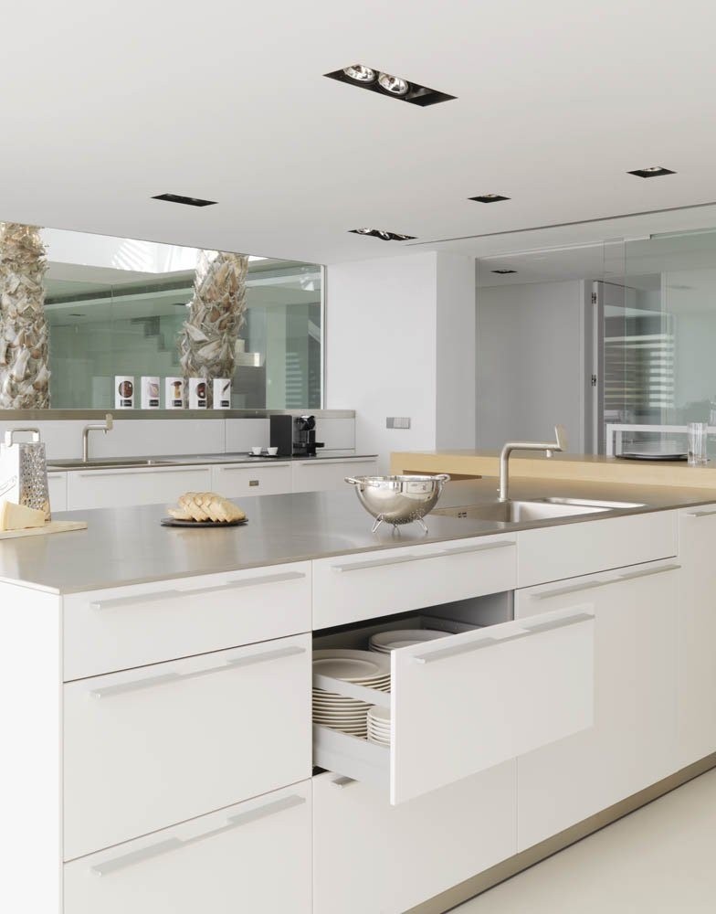 White kitchen with stainless steel backsplash