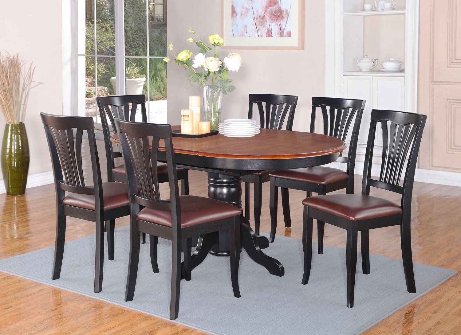 East West Furniture AVON7-BLK-LC 7PC Oval Dining Set with Single Pedestal with 18 in. butterfly leaf and 6 Faux Leather seat chairs