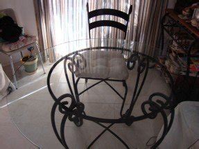 Wrought iron table with glass top and 4 chairs