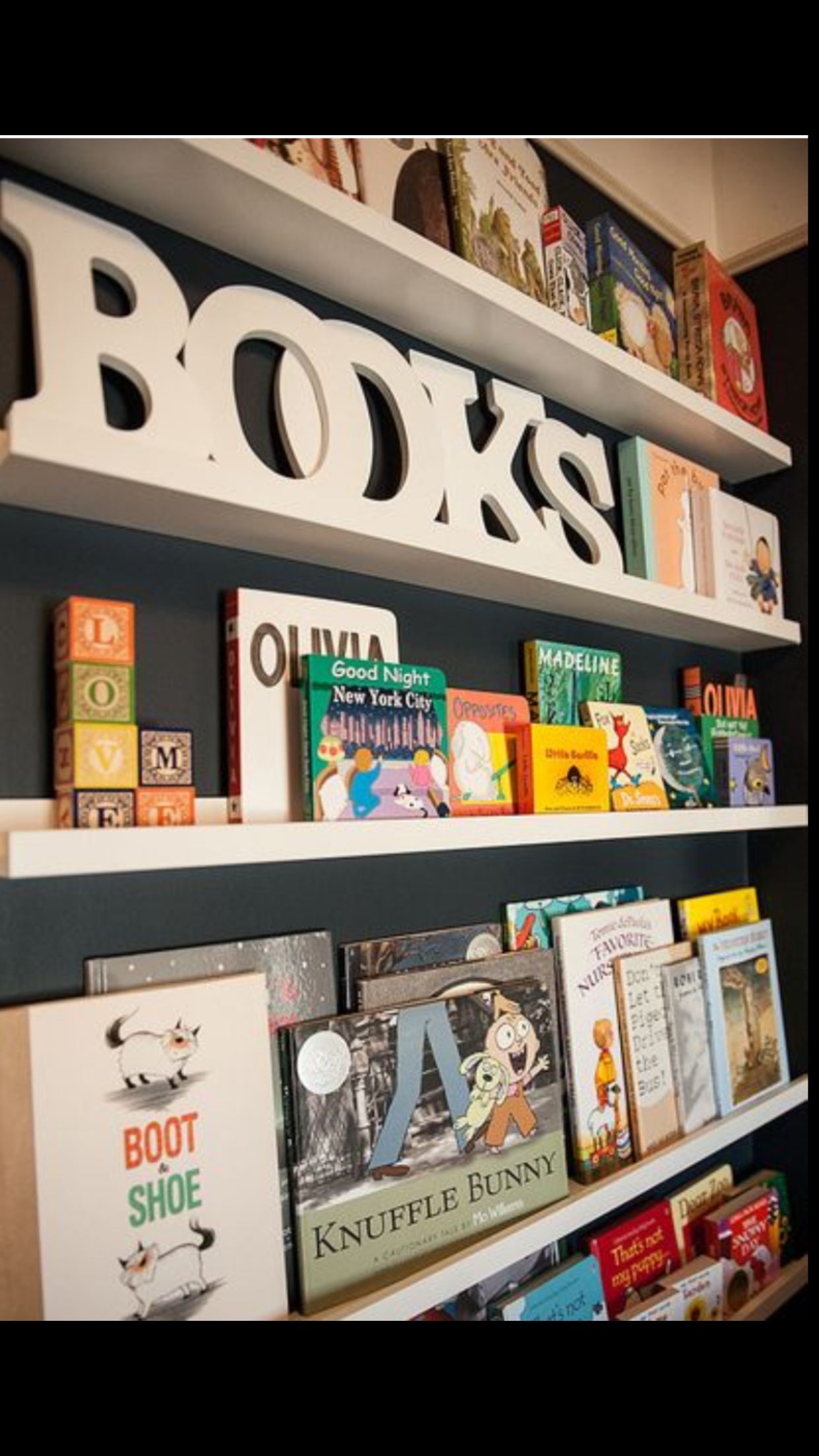 white corner bookshelf for nursery