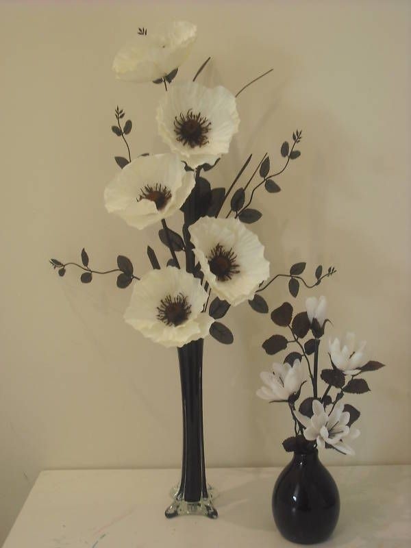 White flower arrangements in tall vases