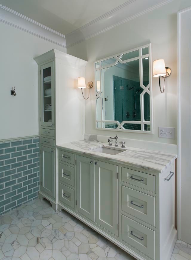 Bathroom with gray green vanity accented with nickel hardware and