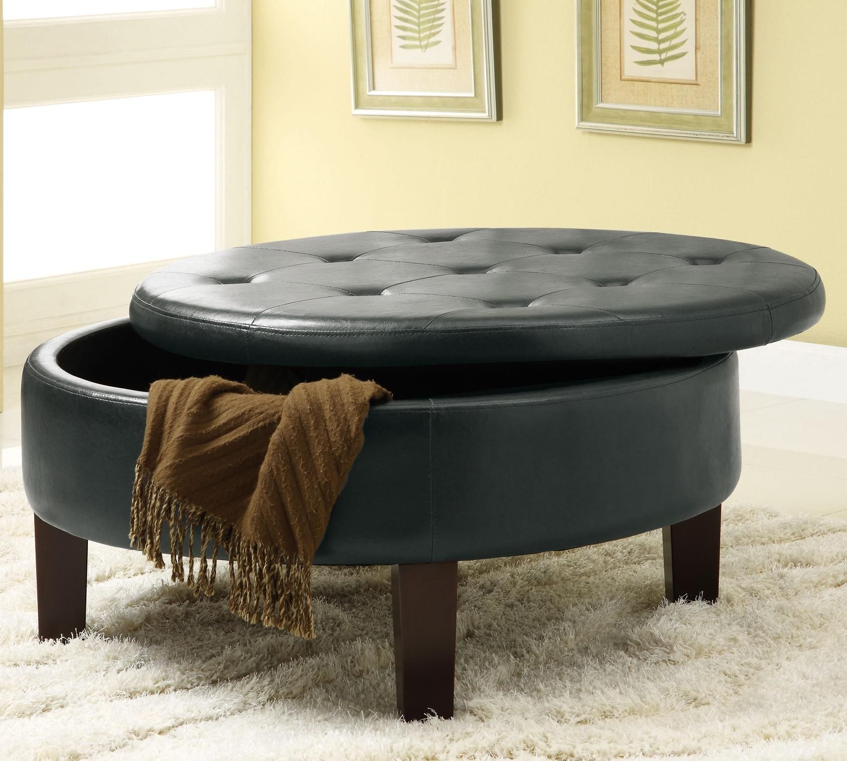 Round upholstered storage ottoman with tufted top