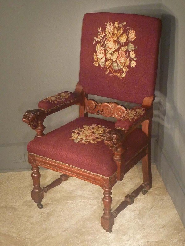 Victorian oak armchair with carved lion heads with needlepoint fabric