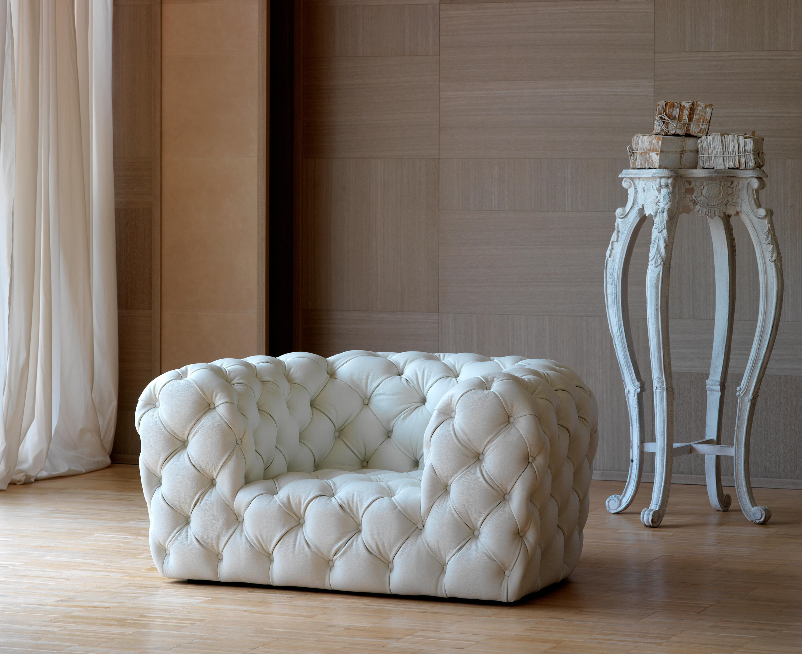 White tufted leather sofa by baxter 2