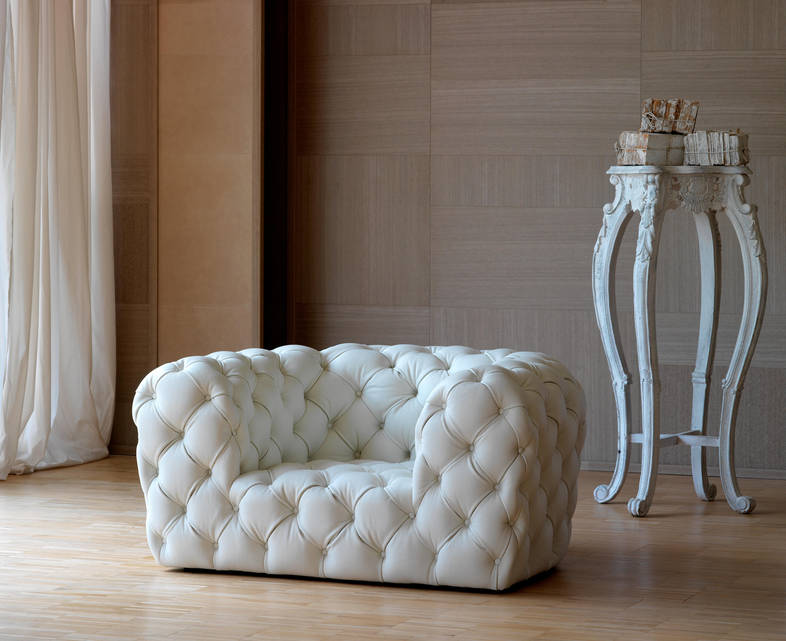 white tufted leather sofa by baxter