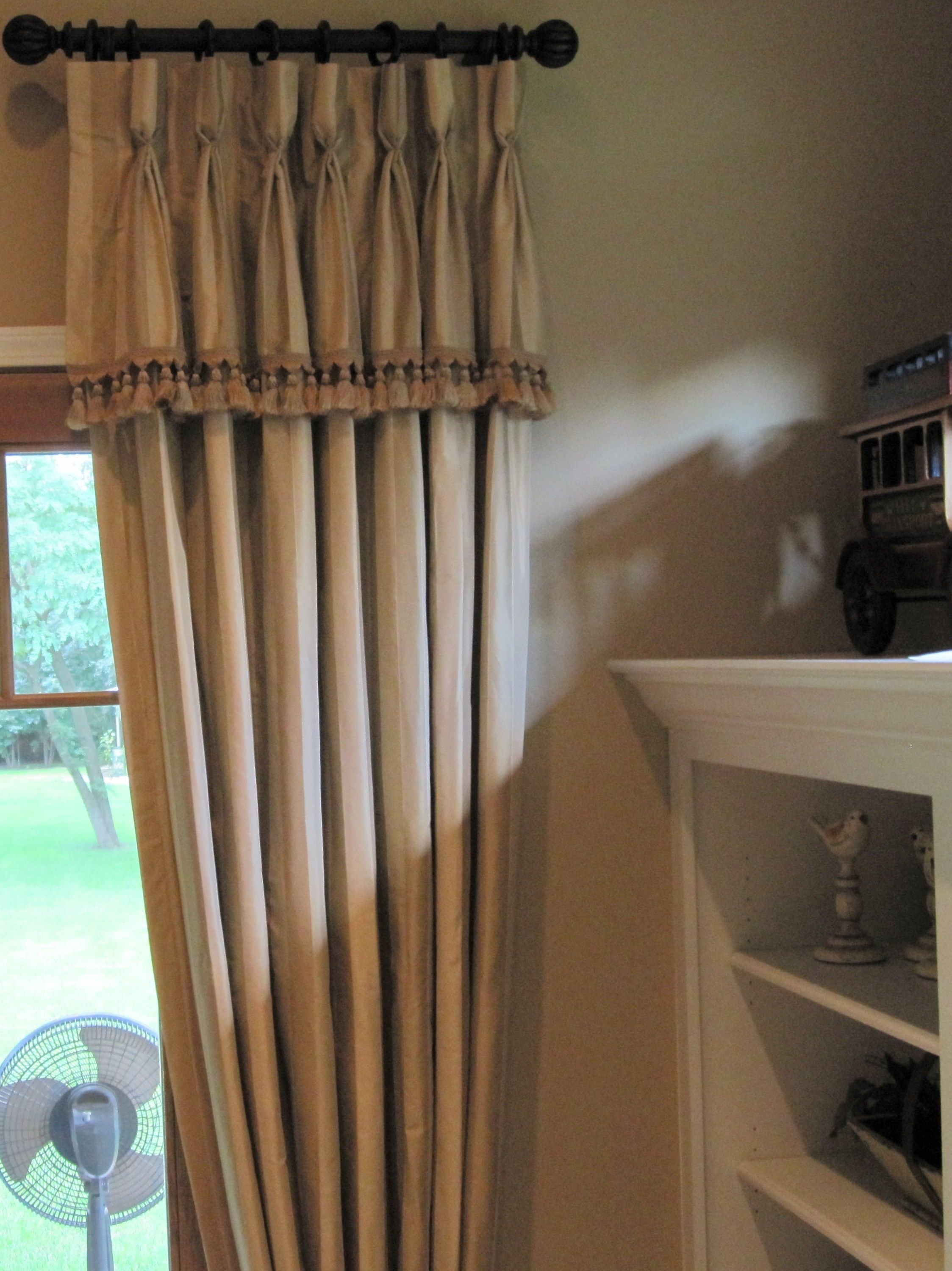 Goblet pleat drapery panels with attached valance trim sometimes called