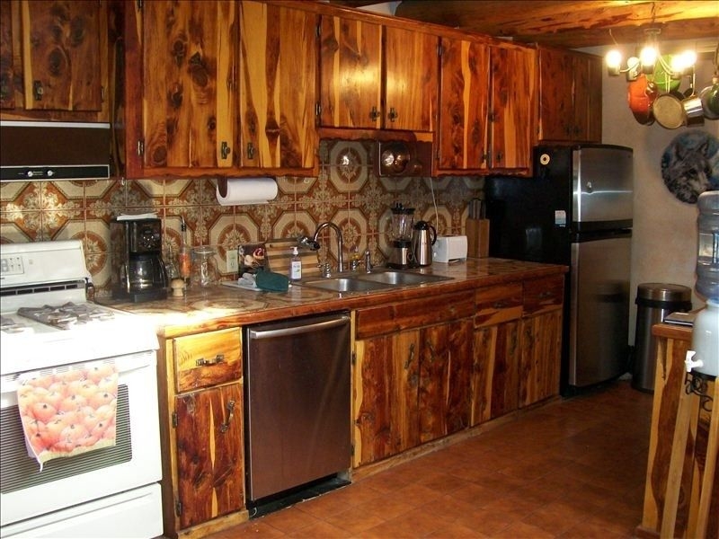 Warm cedar cabinets vigas saltillo tile evoke a mountain feel