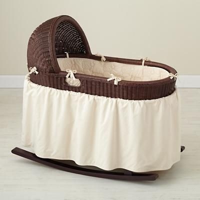 Chocolate brown wicker and cream colored bedding have an organic