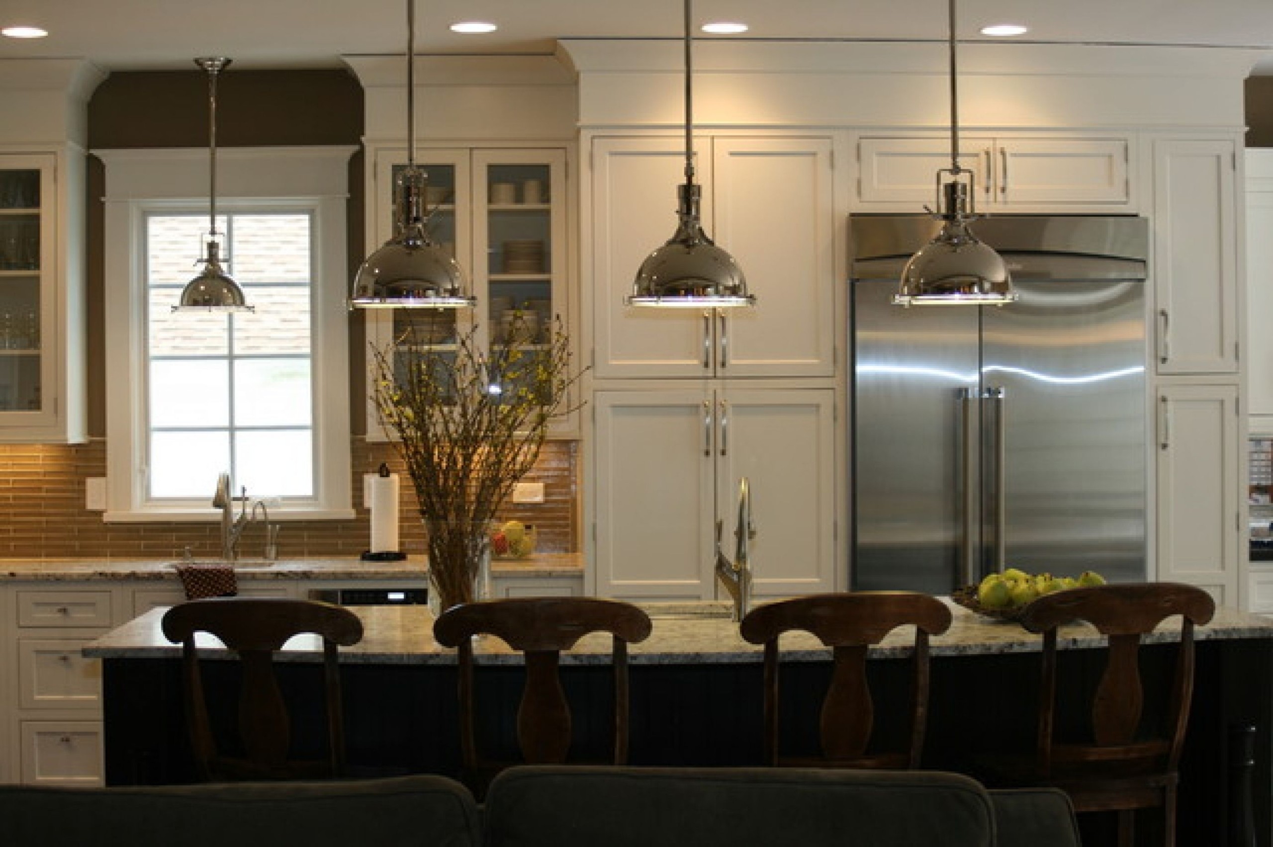 Designed kitchen island with pendant lights bring in a classic