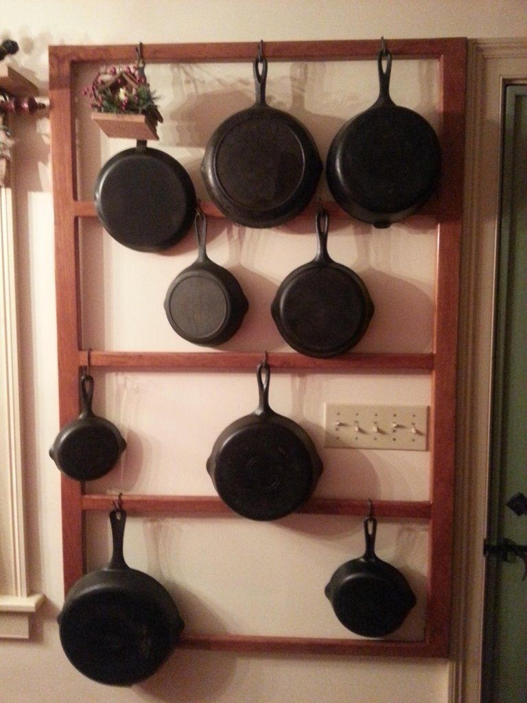 Cast iron pan rack on the wall behind the door. IKEA Rimforsa