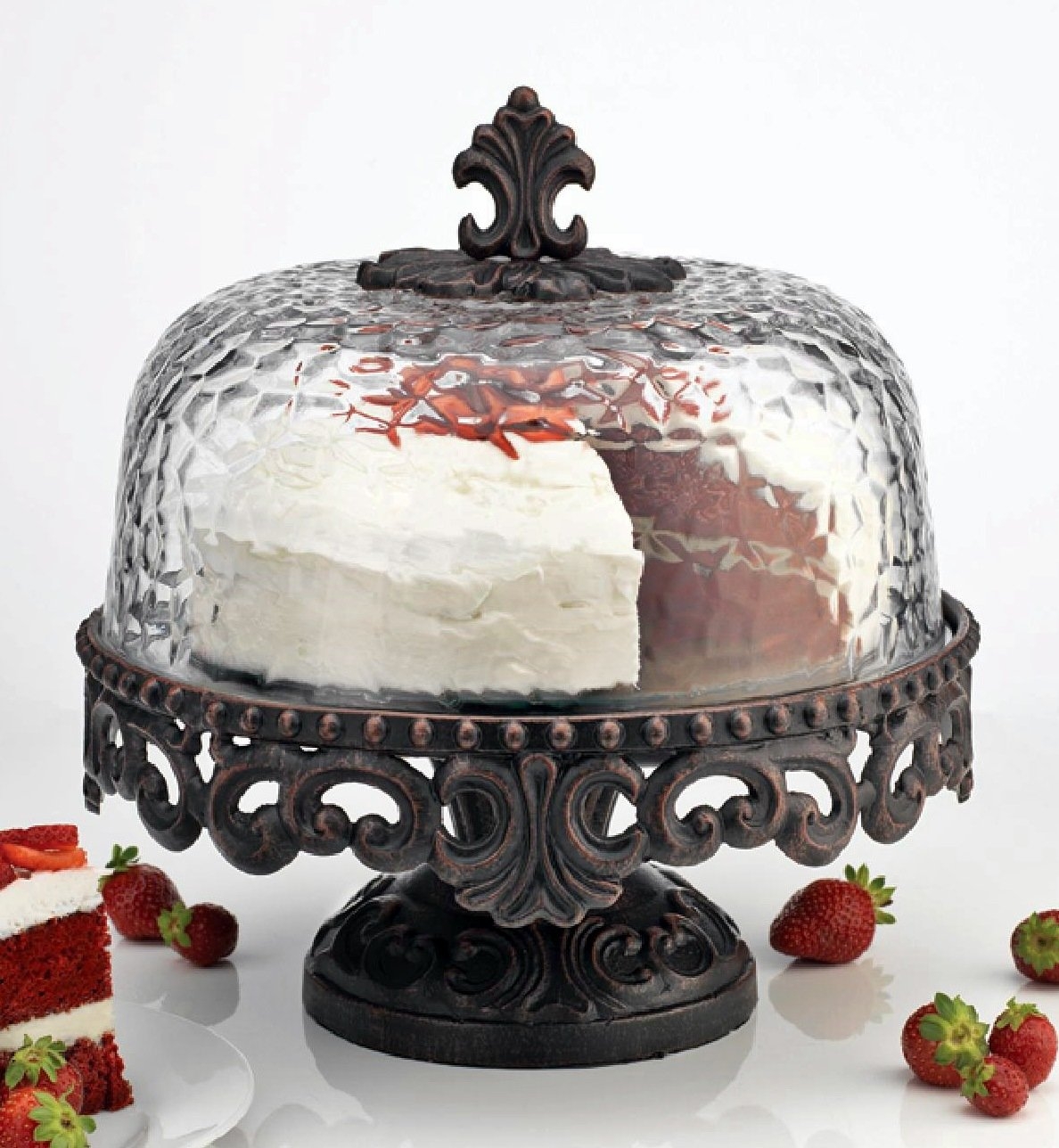 Scrolled metal cake stand with hammered glass dome footed cake