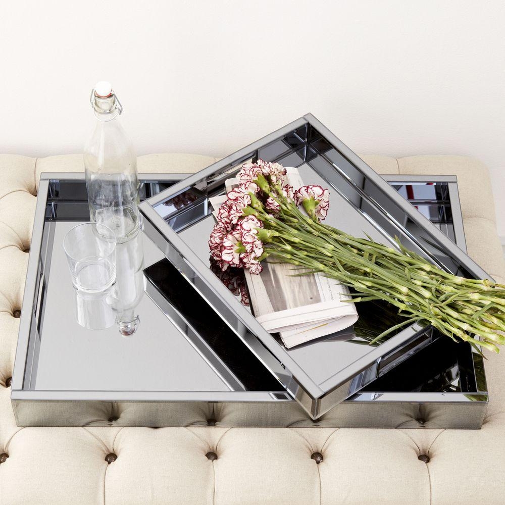 Made of mirrored glass with beveled edges these luminous trays