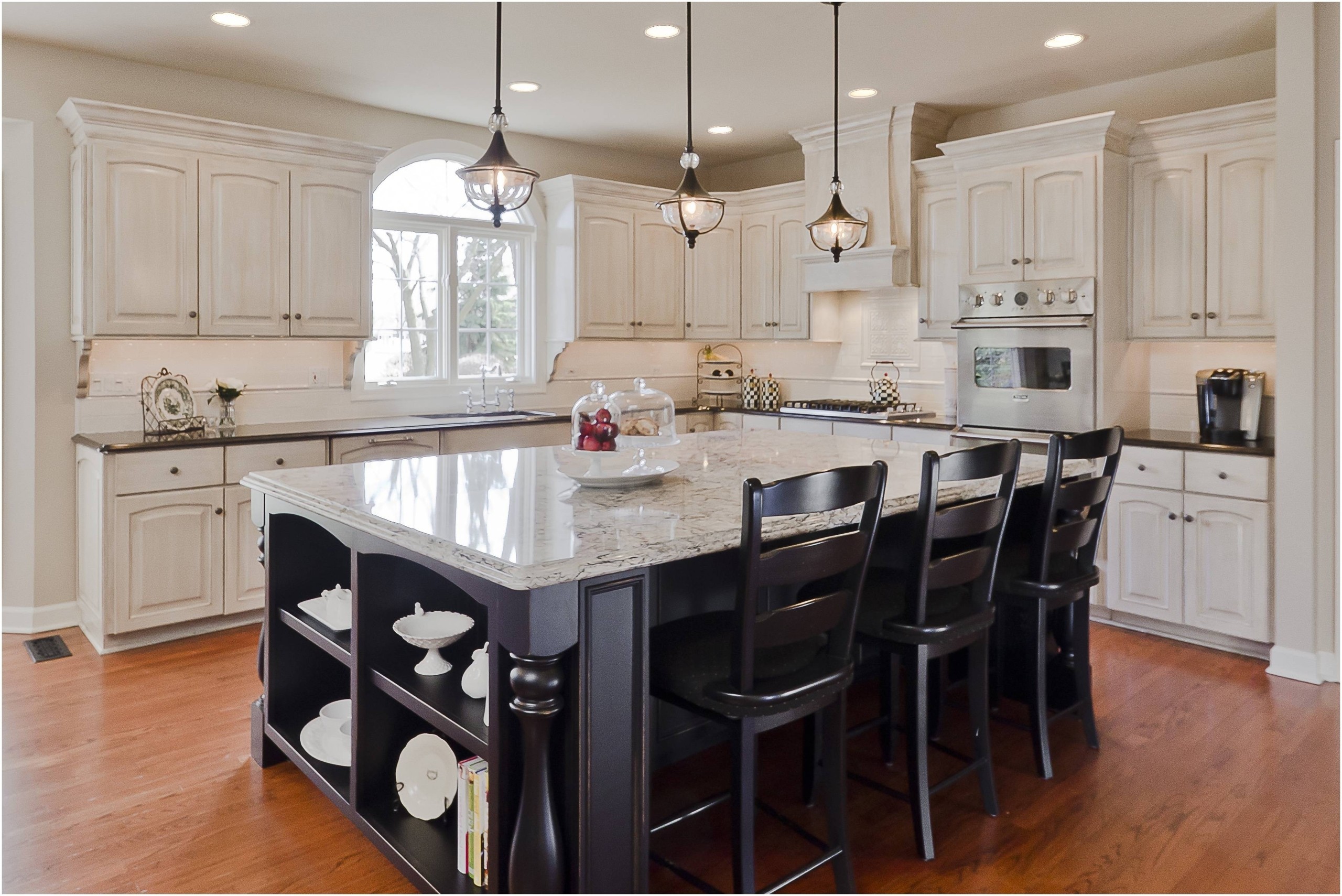Rustic style kitchen island lighting over white gloss granite top