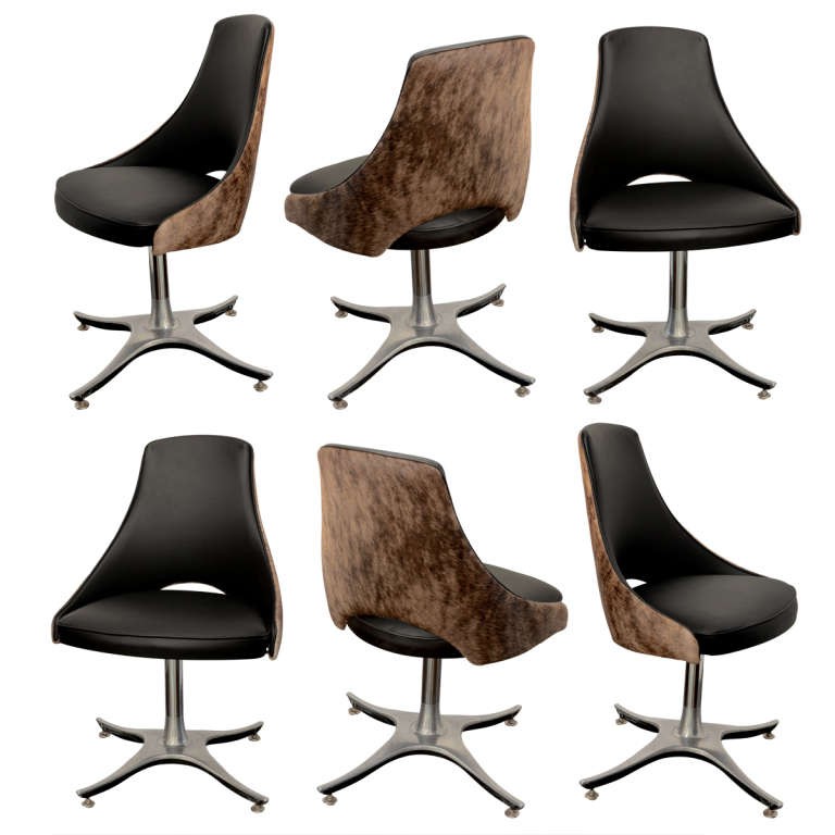 Six leather hide swivel dining chairs