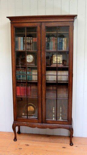 Solid oak two door bookcase with twin astrigal glazed doors