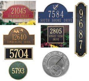 Find plaques on wall mounted curbside mailboxes for the metal