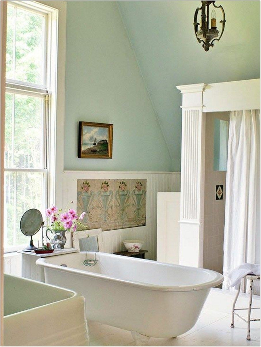 This grand bathroom features a traditional claw foot tub with