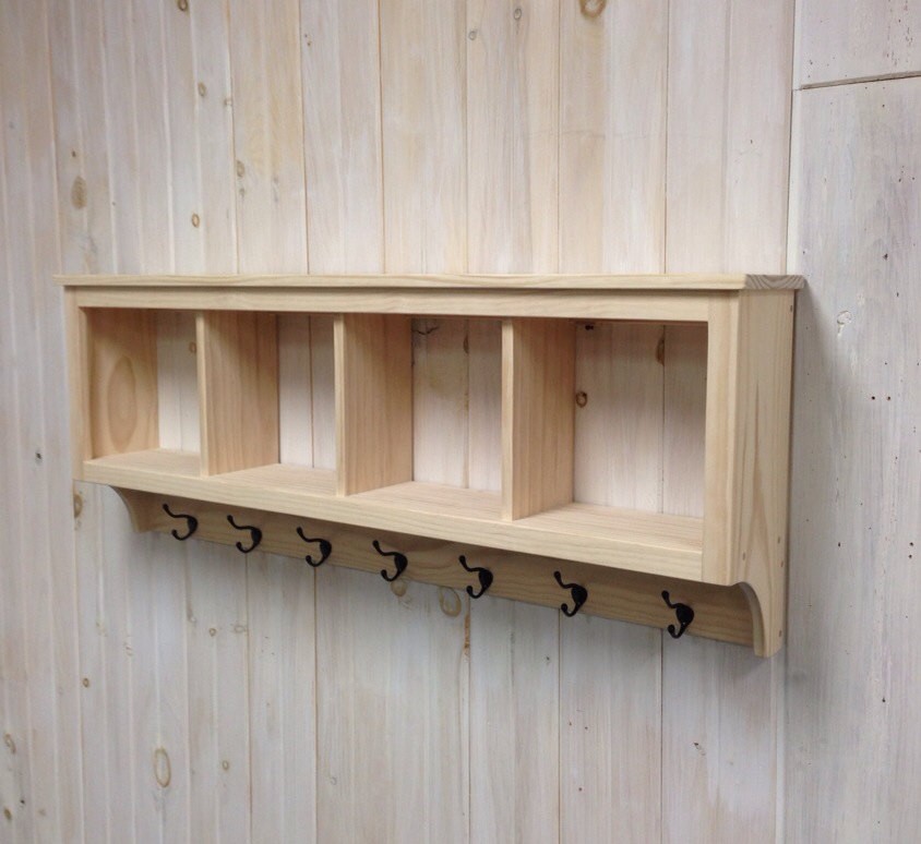 This is a wall mounted shelf with four cubby holes