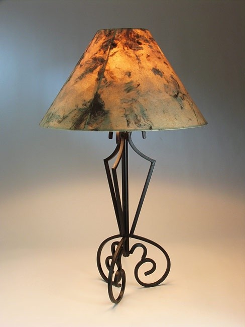 This rustic iron tri base table lamp comes with a