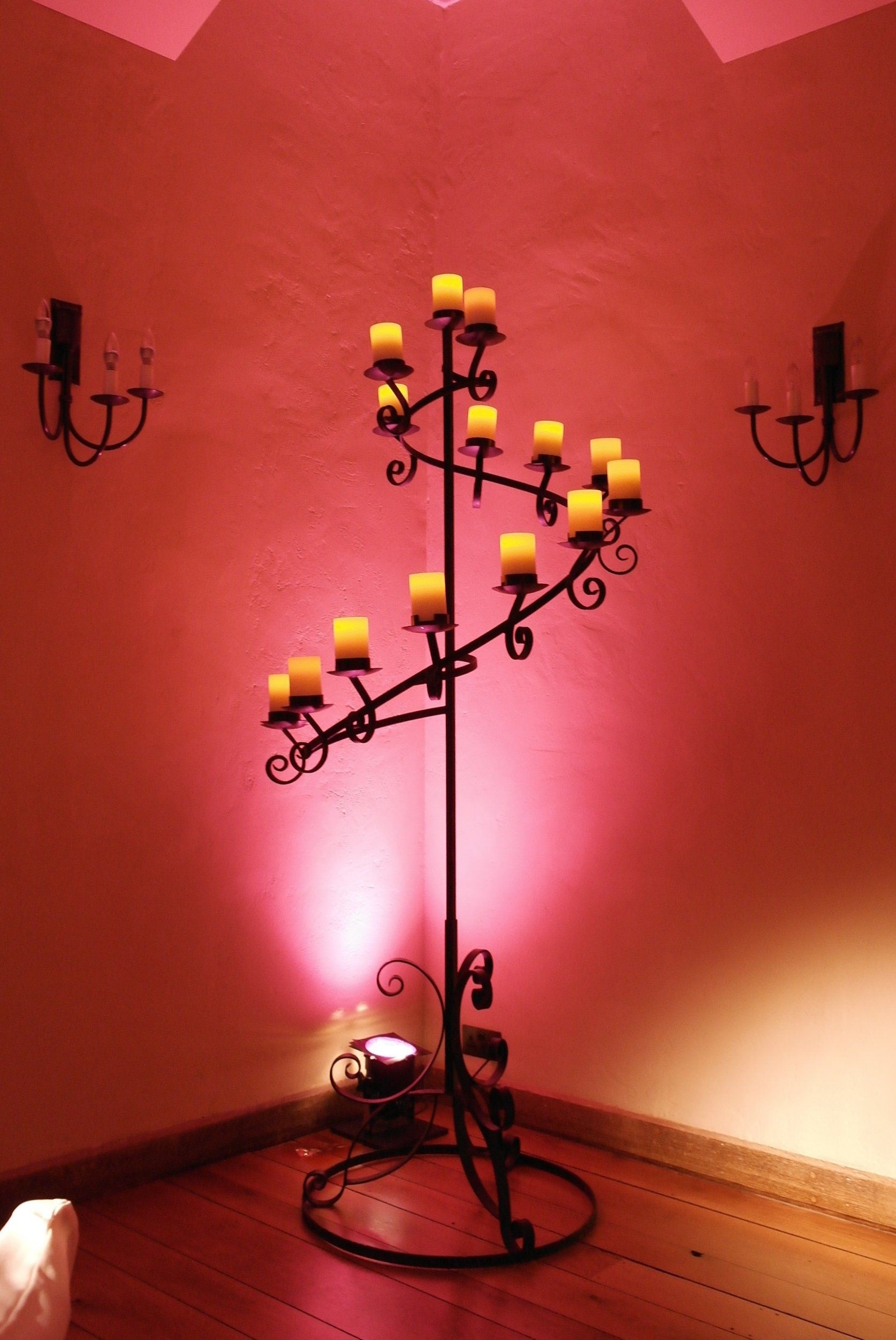 Spiral floor standing candelabra with battery pillar candles and wall