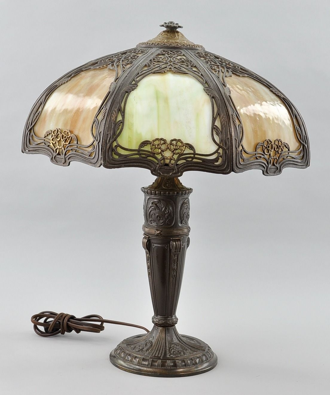 An antique slag glass lamp and shade bronze tone cast