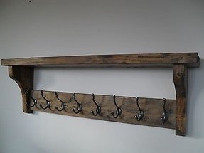 white wooden shelf with hooks