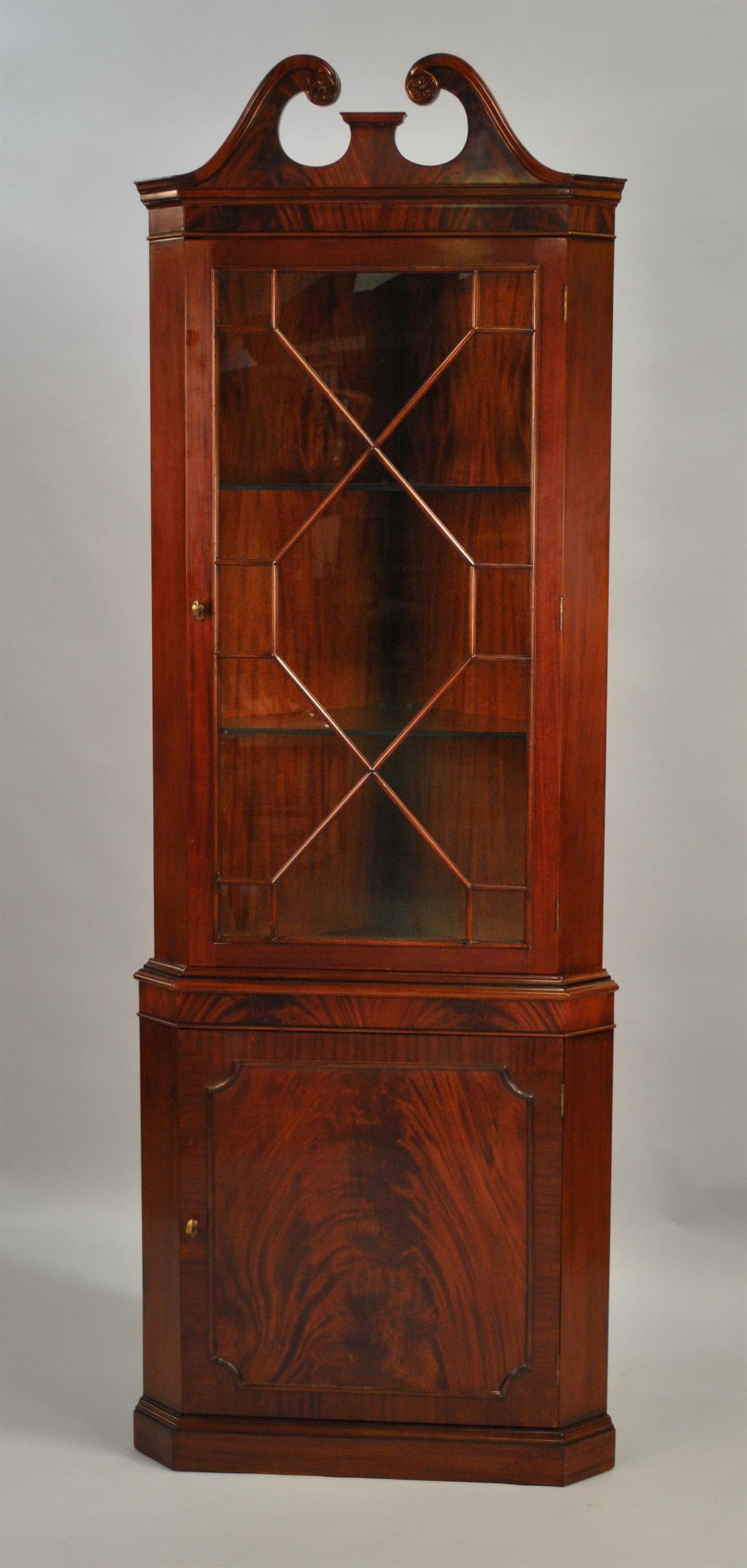 Traditional single door mahogany corner cabinet with broken arch
