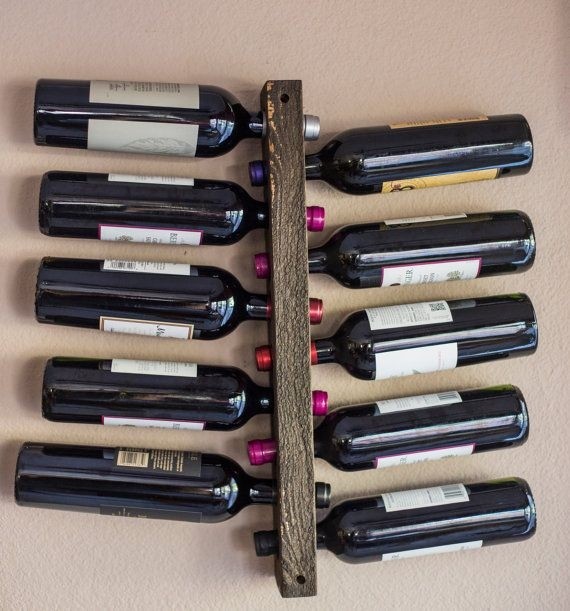 This wood wall mounted vertical wine rack display holds 10