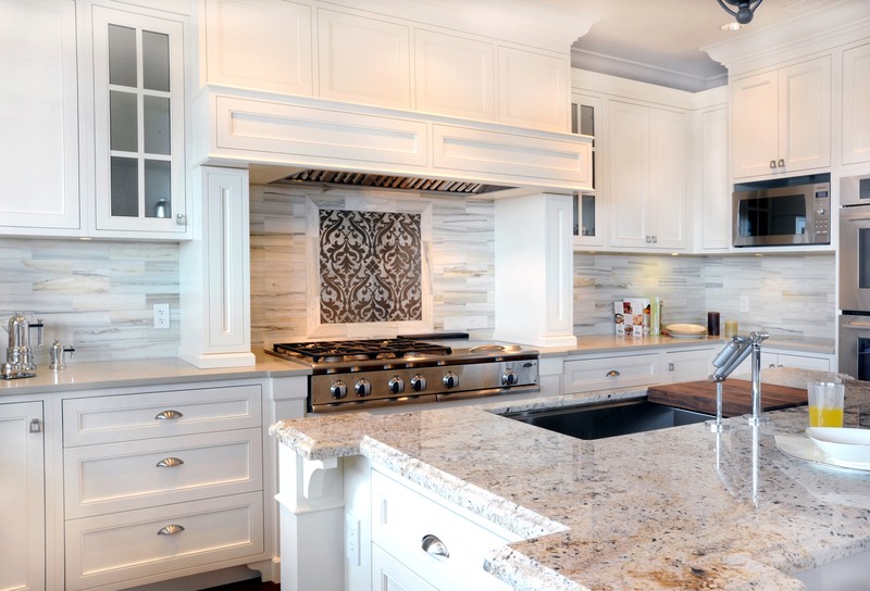 White Contemporary Kitchen With Cinder Caesarstone Countertops With Bianco Romano Granite Island Top White Shaker Kitchen Cabinetry Pale Gray Walls Modern Marble Tile Backsplash And Kitchen Cooktop Da ?s=l