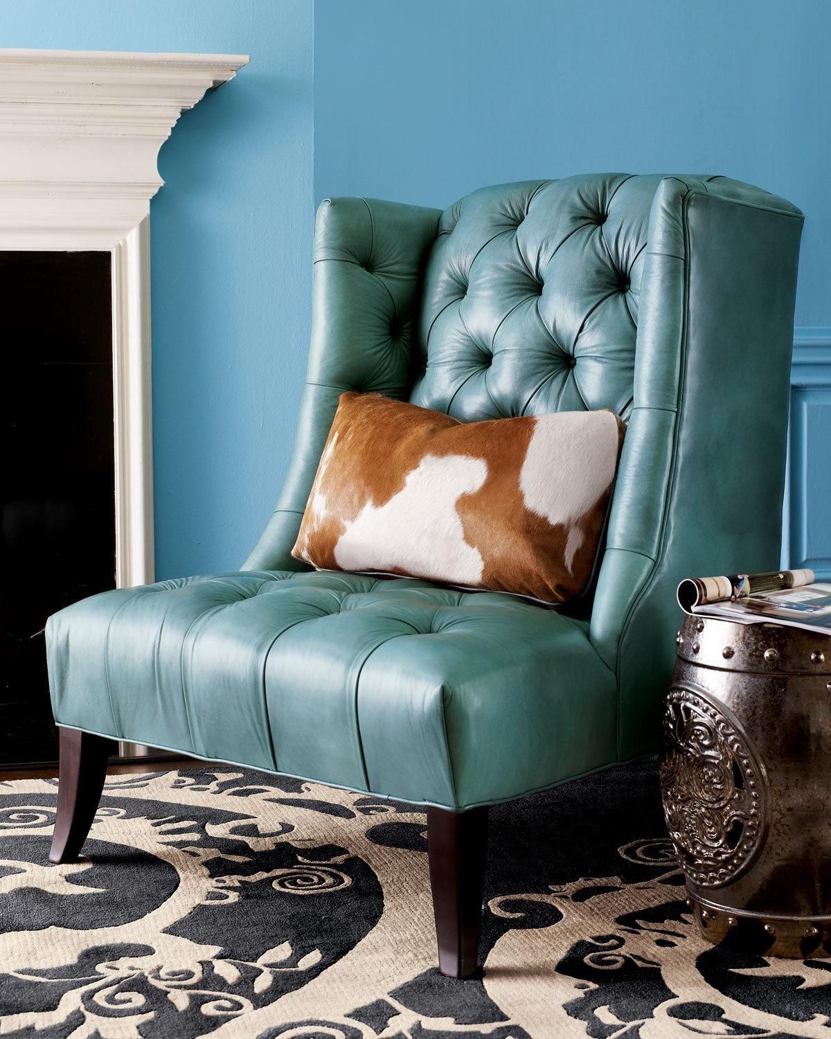 Turquoise leather chair with cowhide pillow