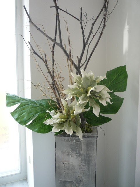 Artificial flower arrangement in green grey brown white flowers with