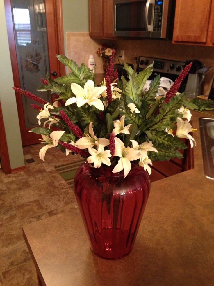 Diy floral arrangement with artificial flowers in antique cranberry glass