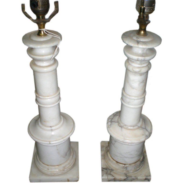 Pair of marble column lamps from a unique collection of