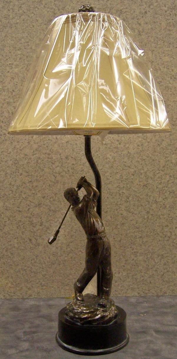 Designed and intricately detailed golfer teeing off table lamp