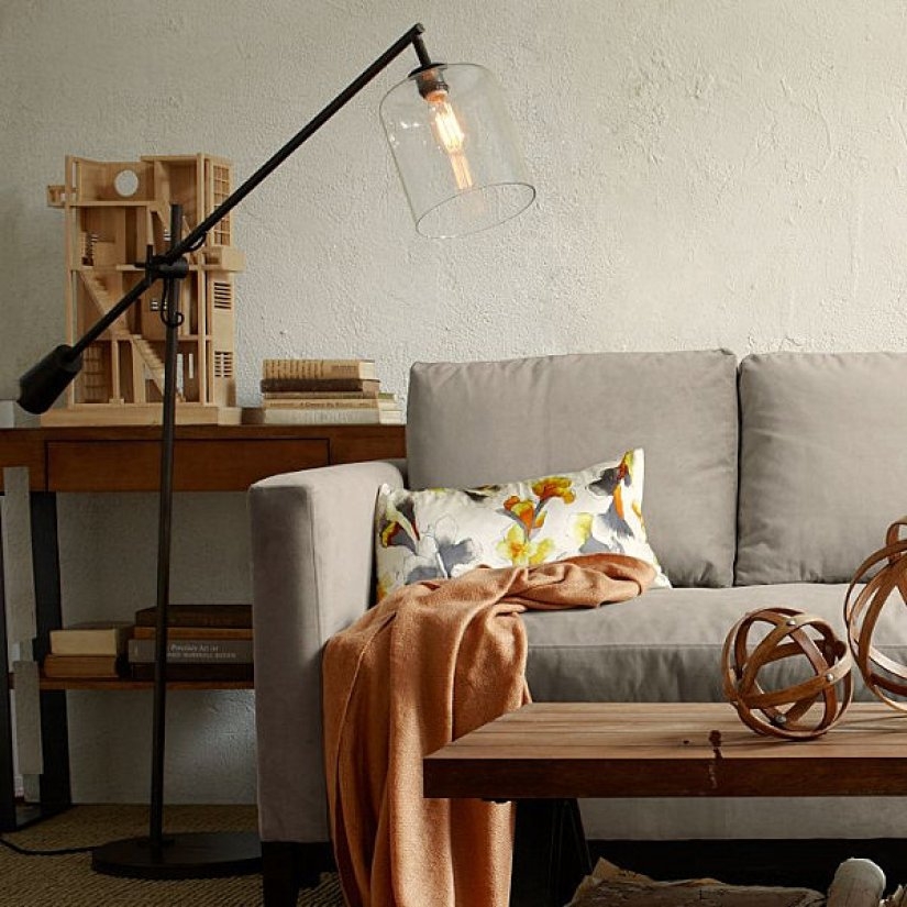 Arch lamp with glass and grey sofa and pillow and