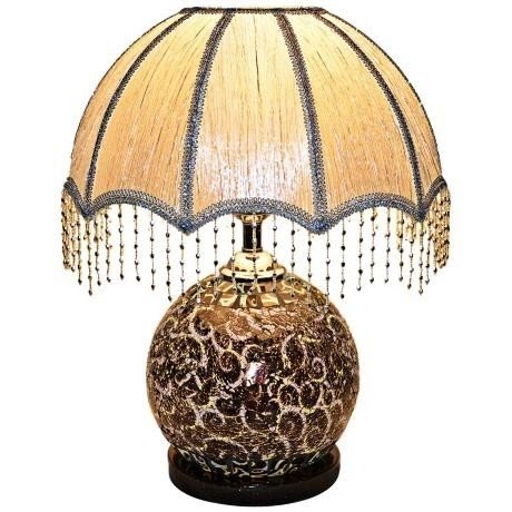 Table lamp topped with a traditional styled lamp shade with