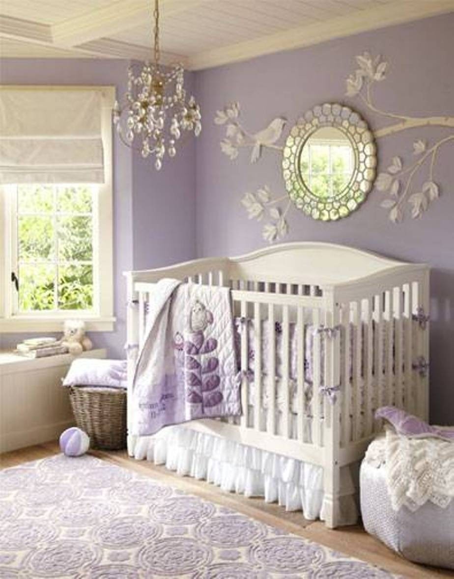 A classically styled white crib pops against lavender walls sheeting