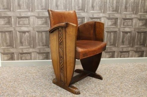This traditional solid oak and leather art deco armchair made